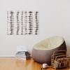 a living room with a bean bag chair next to a stack of books