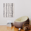 a living room with a bean bag chair next to a stack of books